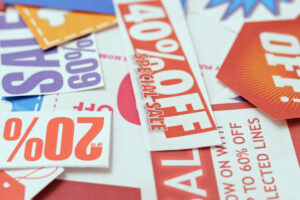 A collection of colorful sale and discount tags featuring various percentages off, including 40% off and 20% off, scattered on a surface.