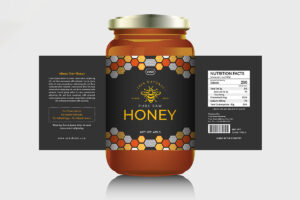 A product mockup of a glass honey jar with a black label design featuring a golden bee illustration, honeycomb patterns, and flat-lay side panels for product description and nutrition facts.